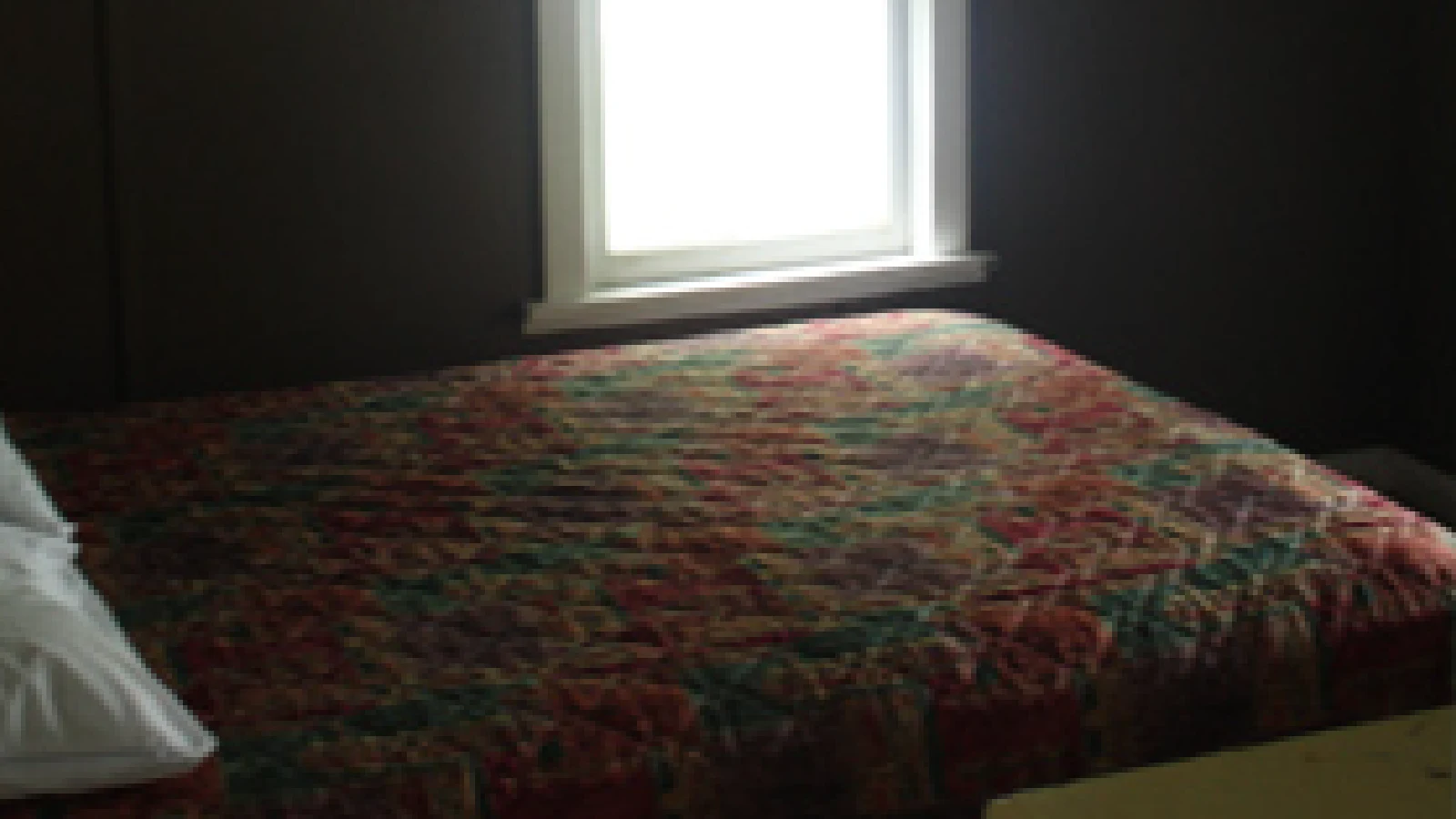 Pigeon Lake Resort Cottage Two.&nbsp; Bedroom with two single beds and a window in a cottage interior.